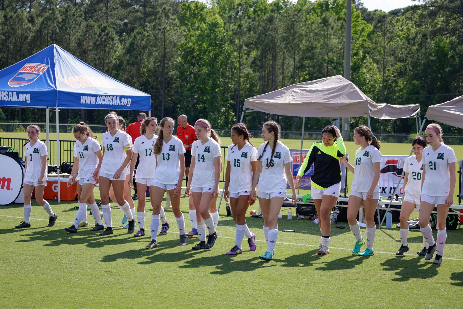 The Woods Charter women's soccer team walks onto the field in the direction of the awards ceremony after the Wolves' 3-0 loss to the Christ the King Crusaders in the 1A state title game last Saturday in Cary.